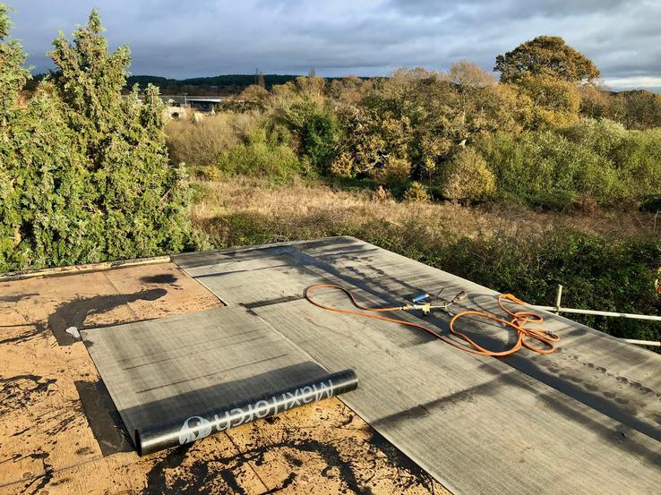 During -Flat roof partly completed, overlooking trees and greenery in Bournemouth 